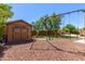 Large backyard with storage shed, playset, and grassy area at 16205 S 7Th St, Phoenix, AZ 85048