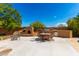 Outdoor kitchen, fireplace, and dining area create an inviting space for entertaining at 16205 S 7Th St, Phoenix, AZ 85048