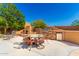 Outdoor kitchen with a stone fireplace and seating area for entertaining at 16205 S 7Th St, Phoenix, AZ 85048