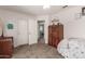 Bedroom with double doors, dresser, and access to hallway at 16205 S 7Th St, Phoenix, AZ 85048