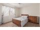 Bedroom with vintage wood bed frame and dresser at 16205 S 7Th St, Phoenix, AZ 85048