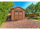 Tan colored storage shed in the backyard at 16205 S 7Th St, Phoenix, AZ 85048