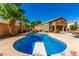 Inviting kidney-shaped pool with diving board, ample patio space, and desert landscaping at 16205 S 7Th St, Phoenix, AZ 85048