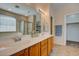 Double vanity bathroom with wood cabinets and a shower at 169 E Canary Ct, San Tan Valley, AZ 85143