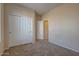 Bedroom with double door closet and access to hallway at 169 E Canary Ct, San Tan Valley, AZ 85143