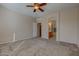 Primary bedroom with ceiling fan and access to bathroom at 169 E Canary Ct, San Tan Valley, AZ 85143