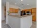 Modern kitchen with wood cabinets and a breakfast bar at 169 E Canary Ct, San Tan Valley, AZ 85143