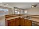 Kitchen with double sink, wood cabinets, and views of backyard at 169 E Canary Ct, San Tan Valley, AZ 85143