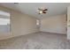 Bright living room featuring large windows and ceiling fan at 169 E Canary Ct, San Tan Valley, AZ 85143