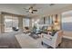 Relaxing living room, featuring a comfy sofa and two armchairs, with access to the backyard at 169 E Canary Ct, San Tan Valley, AZ 85143