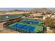 Aerial view of two well-maintained tennis courts in a residential community at 169 E Canary Ct, San Tan Valley, AZ 85143