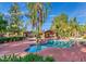 Community pool with a large covered patio and surrounding landscaping at 170 E Guadalupe Rd # 174, Gilbert, AZ 85234