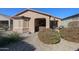 Landscaped backyard with gravel, bushes, and a view of the home at 17563 W Fairview St, Goodyear, AZ 85338