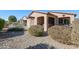 Landscaped backyard with gravel, bushes, and a view of the home at 17563 W Fairview St, Goodyear, AZ 85338