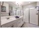 Bright bathroom with double sinks and a shower stall at 17563 W Fairview St, Goodyear, AZ 85338