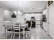 Open concept dining area with white cabinets and kitchen island at 17563 W Fairview St, Goodyear, AZ 85338