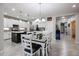 Kitchen and dining area with white cabinets and a center island at 17563 W Fairview St, Goodyear, AZ 85338