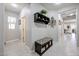 Bright entryway with tiled floors, bench, and coat rack at 17563 W Fairview St, Goodyear, AZ 85338