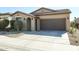 Single story house with a brown garage door and desert landscaping at 17563 W Fairview St, Goodyear, AZ 85338