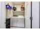 Laundry room features washer, dryer, and storage shelving at 17563 W Fairview St, Goodyear, AZ 85338