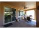 Covered patio with seating area, adjacent to the home's interior at 17563 W Fairview St, Goodyear, AZ 85338