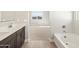 Modern bathroom featuring double vanity, soaking tub, and shower at 17761 W Elm St, Goodyear, AZ 85395