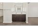 A modern bathroom with a double vanity with dark wood cabinets at 17761 W Elm St, Goodyear, AZ 85395