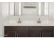 Close-up of double sink vanity with dark wood cabinets and quartz countertops at 17761 W Elm St, Goodyear, AZ 85395