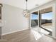 Bright dining area with slider door to backyard and stylish lighting at 17761 W Elm St, Goodyear, AZ 85395