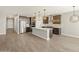 Modern open concept kitchen with a large island, stainless appliances, and designer finishes at 17761 W Elm St, Goodyear, AZ 85395