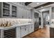 Butler's pantry with wine cooler and glass-front cabinets at 17904 E Veit Springs Dr, Rio Verde, AZ 85263