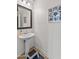 Small bathroom with pedestal sink and mirror at 17909 N 114Th Dr, Surprise, AZ 85378