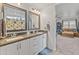 Double vanity bathroom with granite countertops and large mirrors at 17909 N 114Th Dr, Surprise, AZ 85378