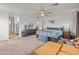 Main bedroom with plush carpeting and ensuite bathroom at 17909 N 114Th Dr, Surprise, AZ 85378