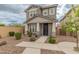 Two-story home with front yard landscaping and walkway at 17909 N 114Th Dr, Surprise, AZ 85378