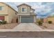 Two-story home with attached garage and attractive landscaping at 17909 N 114Th Dr, Surprise, AZ 85378