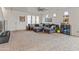 Living room with L-shaped sofa and carpet flooring at 17909 N 114Th Dr, Surprise, AZ 85378