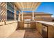 Outdoor kitchen with grill and built-in mini-fridge at 18475 W Via Del Sol --, Surprise, AZ 85387