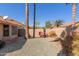 Gravel backyard with desert landscaping and a small cart at 19633 N Marble Dr, Sun City West, AZ 85375