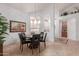 Bright dining area with a round table and six chairs, near entryway at 19633 N Marble Dr, Sun City West, AZ 85375