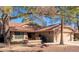 Tan two-story house with a tile roof, fountain, and two-car garage at 19633 N Marble Dr, Sun City West, AZ 85375