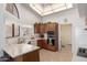 Kitchen with wood cabinets, corner sink, and a view to backyard at 19633 N Marble Dr, Sun City West, AZ 85375