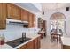 Kitchen with wood cabinets, cooktop, and a view to backyard at 19633 N Marble Dr, Sun City West, AZ 85375