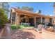 Covered patio with seating area, artificial turf, and adjacent to the house at 19633 N Marble Dr, Sun City West, AZ 85375