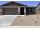 Charming single-story home with desert landscaping, a two-car garage, and a welcoming front porch at 20612 N 226Th Dr, Surprise, AZ 85387