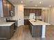 Modern kitchen featuring stainless steel appliances, a quartz countertop island, and stylish cabinetry at 20612 N 226Th Dr, Surprise, AZ 85387