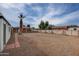 Spacious backyard with detached garage, palm tree, and gravel at 2112 W Mulberry Dr, Phoenix, AZ 85015