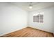 Simple bedroom with a window, ceiling fan, and light wood floors at 2112 W Mulberry Dr, Phoenix, AZ 85015