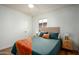 Spacious bedroom with a teal comforter, ceiling fan, and wood-look floors at 2112 W Mulberry Dr, Phoenix, AZ 85015