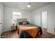 Cozy bedroom with a teal comforter, ceiling fan, and wood-look floors at 2112 W Mulberry Dr, Phoenix, AZ 85015